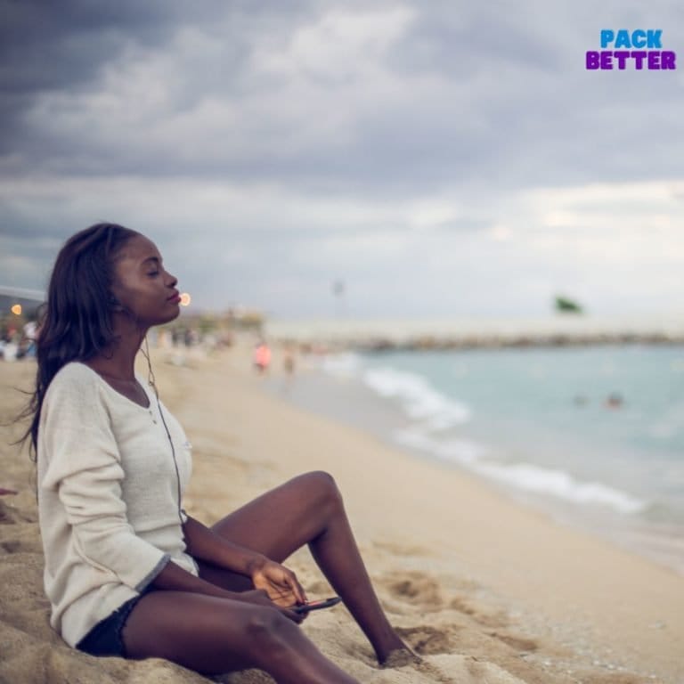 Black woman sitting on beach