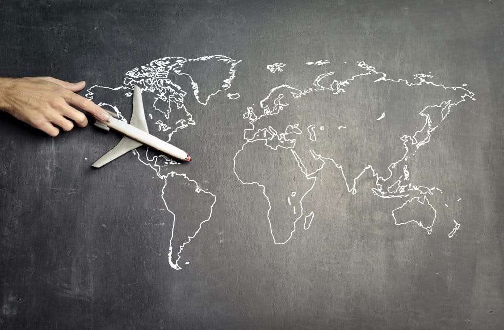 chalkboard map of the world with airplane