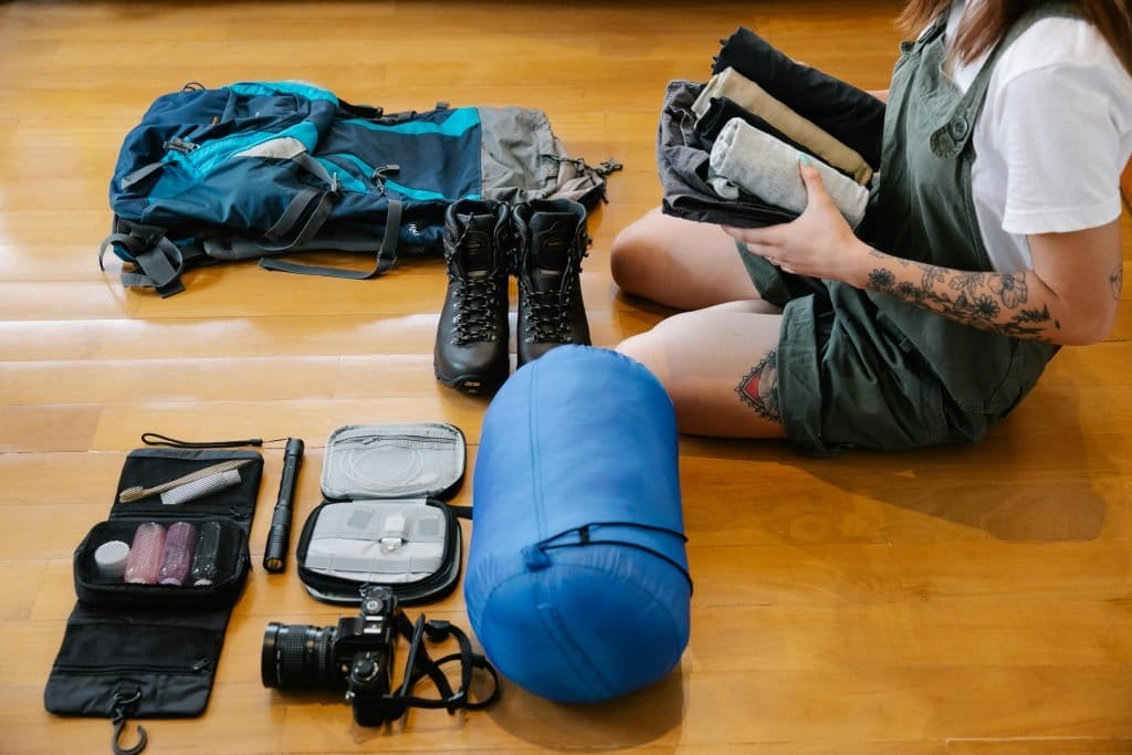 woman with tattoos sitting on hardwood floor packing