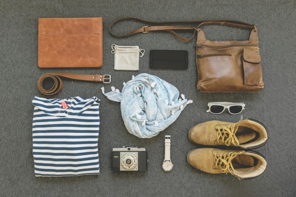 collage of travel accessories on ground - top view