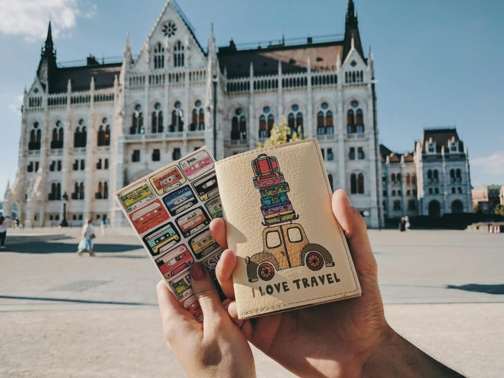 passport covers in front of a landmark