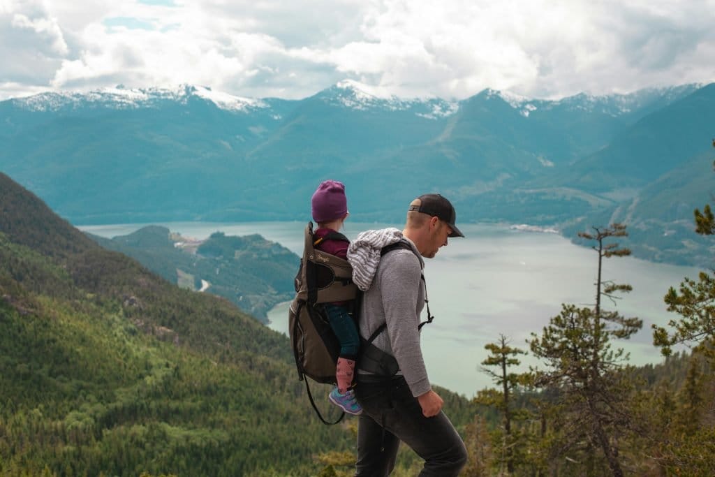 father hiking with toddler on back pack